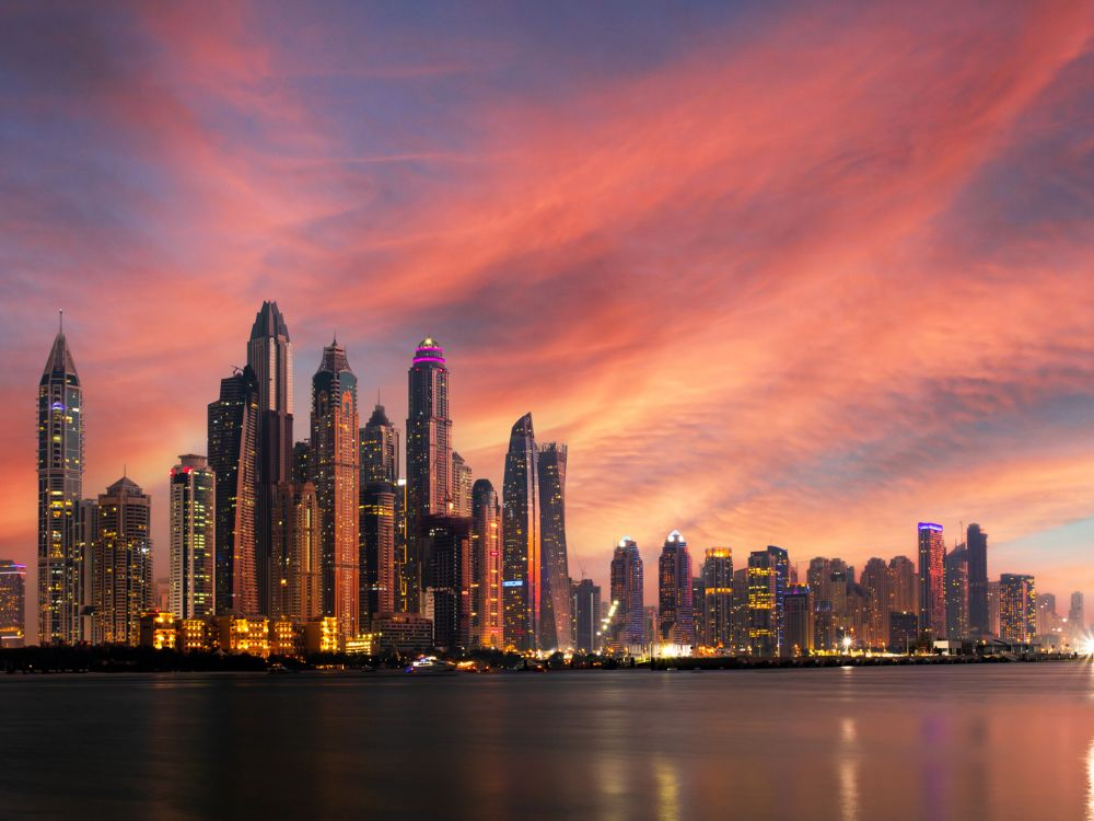 UAE weather shift casting a pink glow at sunset.