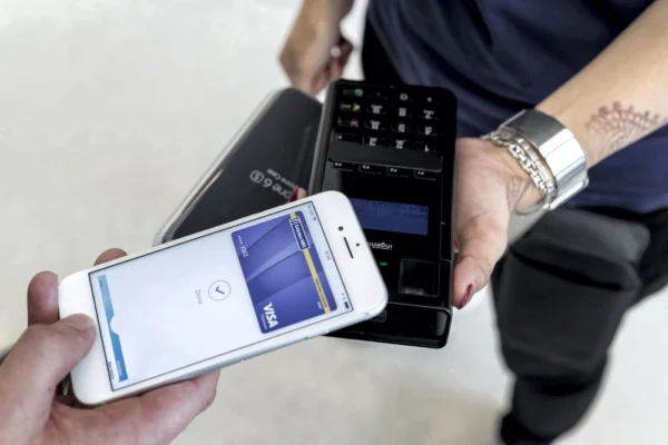 “Dubai goes cashless: resident using digital wallet at a store”
