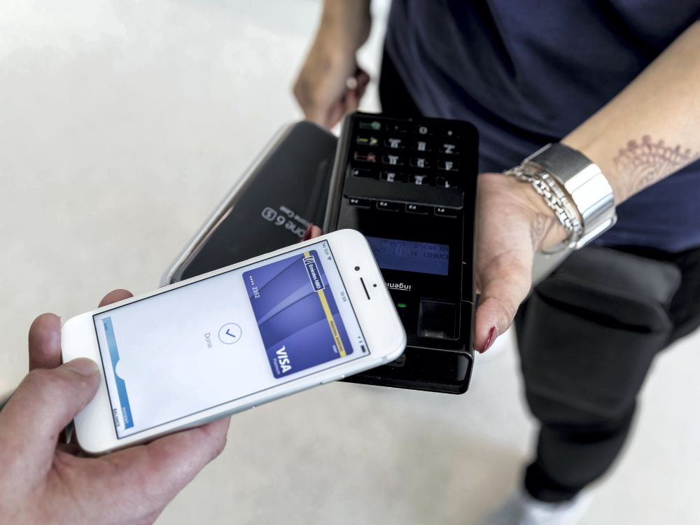 “Dubai goes cashless: resident using digital wallet at a store”