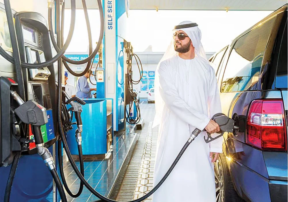 Man filling petrol after UAE petrol prices for December 2025 announced.