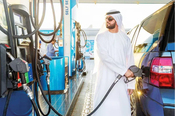 Man filling petrol after UAE petrol prices for December 2025 announced.