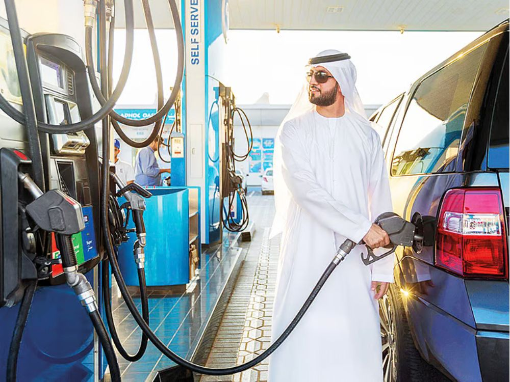 Man filling petrol after UAE petrol prices for December 2025 announced.